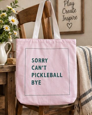 Soft pink canvas tote reading Sorry Can't Pickleball Bye, with plain white straps